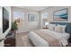 This main bedroom is well-lit and features two large windows and neutral decor at 136 S Bell Ave, Albemarle, NC 28001