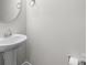 Powder room features white pedestal sink at 136 S Bell Ave, Albemarle, NC 28001