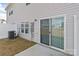 A backyard with an AC unit, a white fence, a sliding glass door, and a small concrete patio at 138 S Bell Ave, Albemarle, NC 28001