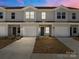 Charming townhomes with attached garages and inviting curb appeal under a colorful sky at 138 S Bell Ave, Albemarle, NC 28001