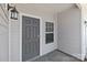 Close up of the front door, featuring a stylish gray door, sidelight, and modern sconces at 138 S Bell Ave, Albemarle, NC 28001