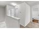 Upstairs hallway with carpeted floor leading to bedrooms and bathrooms at 138 S Bell Ave, Albemarle, NC 28001