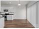 Bright kitchen featuring stainless steel appliances, granite countertops, and a view into the dining area at 138 S Bell Ave, Albemarle, NC 28001