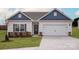 Charming single Gathering home showcasing a 2-car garage, stone accents, and manicured lawn at 146 Jacobs Hill Pl, Troutman, NC 28166