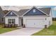 Charming single Gathering home showcasing a 2-car garage, stone accents, and manicured lawn at 146 Jacobs Hill Pl, Troutman, NC 28166