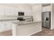 Bright kitchen featuring white cabinetry, granite countertops, and stainless steel appliances at 146 Jacobs Hill Pl, Troutman, NC 28166
