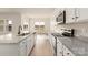 Beautiful open kitchen featuring white cabinetry, granite countertops, and stainless steel appliances at 146 Jacobs Hill Pl, Troutman, NC 28166