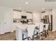 Bright kitchen with stainless steel appliances, a large island, and white cabinetry at 151 Mountain Bridge Way, Statesville, NC 28625