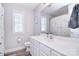 Bright bathroom with patterned shower curtain, window, and modern white vanity and toilet at 1516 Bucklebury Ct, Charlotte, NC 28269