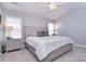 Bright main bedroom featuring neutral walls, carpet, ceiling fan, and bedside tables with lamps at 1516 Bucklebury Ct, Charlotte, NC 28269