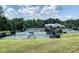 Well-maintained tennis courts surrounded by lush trees, perfect for friendly matches or serious competition at 19622 River Falls Dr, Davidson, NC 28036