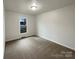 Cozy bedroom featuring neutral carpeting and ample natural light from a large window at 1971 Bristol Pkwy, Rock Hill, SC 29732