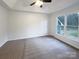 Neutral bedroom with a tray ceiling, ample natural light, and neutral carpet at 1971 Bristol Pkwy, Rock Hill, SC 29732