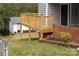 Backyard view of wooden porch extension over a brick and red rock garden at 219 Ferstl Ave, Belmont, NC 28012