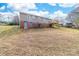 Wide backyard view featuring a wood deck, door to basement, and a gentle slope at 219 Ferstl Ave, Belmont, NC 28012