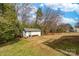 Large backyard featuring mature trees, a separate utility building, and generous outdoor space at 219 Ferstl Ave, Belmont, NC 28012
