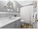 Bright bathroom with a gray vanity, framed mirror, updated fixtures and shower-tub combo at 219 Ferstl Ave, Belmont, NC 28012