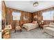 Cozy bedroom with wood paneled walls, carpet flooring, and natural light from two windows at 219 Ferstl Ave, Belmont, NC 28012