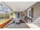 Cozy covered patio with seating and storage, ideal for relaxing outdoors at 219 Ferstl Ave, Belmont, NC 28012