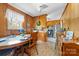 Cozy dining area with a wooden table and chairs, and adjacent kitchen with wood paneling at 219 Ferstl Ave, Belmont, NC 28012