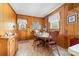 Traditional dining area featuring wood paneled walls and a matching wood dining set at 219 Ferstl Ave, Belmont, NC 28012
