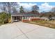 Well-kept single-story home featuring neutral siding, brick accents, and a spacious driveway at 219 Ferstl Ave, Belmont, NC 28012