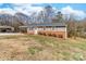 Charming one-story home featuring a cozy covered front porch and an appealing brick facade at 219 Ferstl Ave, Belmont, NC 28012