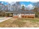 Charming single-story home with brick accents, inviting entrance, and well-maintained landscaping at 219 Ferstl Ave, Belmont, NC 28012