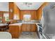 Cozy kitchen featuring wooden cabinets, tile flooring, and stainless steel appliances at 219 Ferstl Ave, Belmont, NC 28012