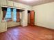 Bedroom featuring hardwood floors, a window with curtains, and a built-in cabinet at 2412 Daves Dr, Shelby, NC 28152