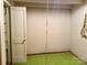 Bedroom featuring a bright green carpet and a white door at 2412 Daves Dr, Shelby, NC 28152