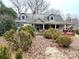 Quaint home with dormers, covered porch, and mature landscaping, awaiting a creative renovation at 2412 Daves Dr, Shelby, NC 28152