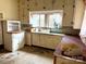 Kitchen featuring classic cabinetry and a large window, needs updating at 2412 Daves Dr, Shelby, NC 28152