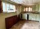 Dilapidated kitchen with outdated cabinets and significant visible damage at 2412 Daves Dr, Shelby, NC 28152