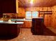 Retro kitchen with knotty pine walls, an eat-in bar, and vintage cabinets at 2412 Daves Dr, Shelby, NC 28152