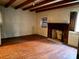 Living room features hardwood floors, exposed ceiling beams, and a brick fireplace at 2412 Daves Dr, Shelby, NC 28152
