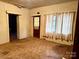 Living room with tiled floors, windows with curtains and access to another room at 2412 Daves Dr, Shelby, NC 28152
