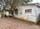 Showing the side exterior with peeling paint and access to the covered porch at 2412 Daves Dr, Shelby, NC 28152