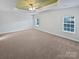 Spacious bedroom with a tray ceiling, plush carpet, and filled with natural light from multiple windows at 2802 Eagle View Ln, Monroe, NC 28110