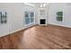 Bright living room featuring hardwood floors, fireplace, and natural light from large windows at 2802 Eagle View Ln, Monroe, NC 28110