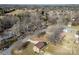 Aerial view of property showing mature trees and a cozy brick home in a peaceful neighborhood at 305 Plantation Dr, Kings Mountain, NC 28086