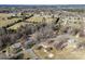 Discover a rural property with open acreage, mature trees, and a cozy brick home in this aerial view at 305 Plantation Dr, Kings Mountain, NC 28086