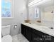 Bathroom featuring double sinks in vanity, large mirror, white toilet, and shower at 305 Plantation Dr, Kings Mountain, NC 28086