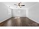 Large bedroom featuring wood-look floors, neutral wall paint, two windows and ceiling fan at 305 Plantation Dr, Kings Mountain, NC 28086