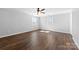 Large bedroom featuring wood-look floors, neutral wall paint, two windows and ceiling fan at 305 Plantation Dr, Kings Mountain, NC 28086