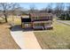 Two story brick home with mature landscaping and a long driveway on a sunny day at 305 Plantation Dr, Kings Mountain, NC 28086