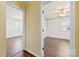 Hallway view showing bedrooms with wood-look floors and neutral paint at 305 Plantation Dr, Kings Mountain, NC 28086