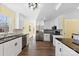 Updated kitchen with modern stainless steel appliances, white cabinets, and dark countertops at 305 Plantation Dr, Kings Mountain, NC 28086