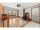 Cozy living room featuring a wood-burning stove, hardwood floors, and natural light from multiple windows at 305 Plantation Dr, Kings Mountain, NC 28086
