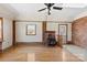 Bright living room with hardwood floors, wood-burning stove, and natural light from multiple windows at 305 Plantation Dr, Kings Mountain, NC 28086